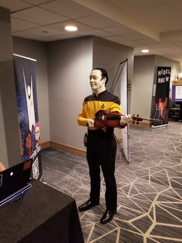 Sarah and Allie with Data cosplayer holding a violin signed by Brent Spiner