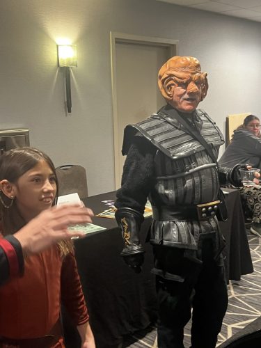 The Ferengi/Klingon appears entertained by young Kira's story