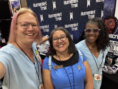 Sarah and Allie in Tantalus Penal Colony jumpsuits with a convention guest in blue TOS uniform.