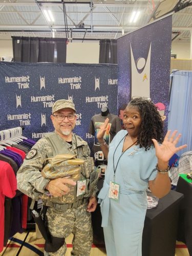 Allie in Tantalus Penal Colony jumpsuits with a convention guest.