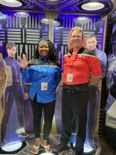 Sarah and Allie beam into the USS Tiburon Transporter Room (wearing Lower Decks uniforms)