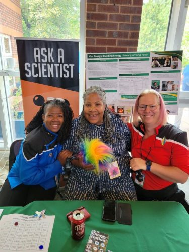 Sarah and Allie in Lower Decks uniforms pose with Ms. Melody Mobley, the first black woman to serve as a forester for the USDA.